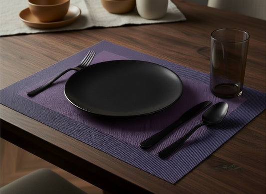 Eclectic ASA Selection plum PVC placemat with a woven texture on a dark wooden table with black tableware