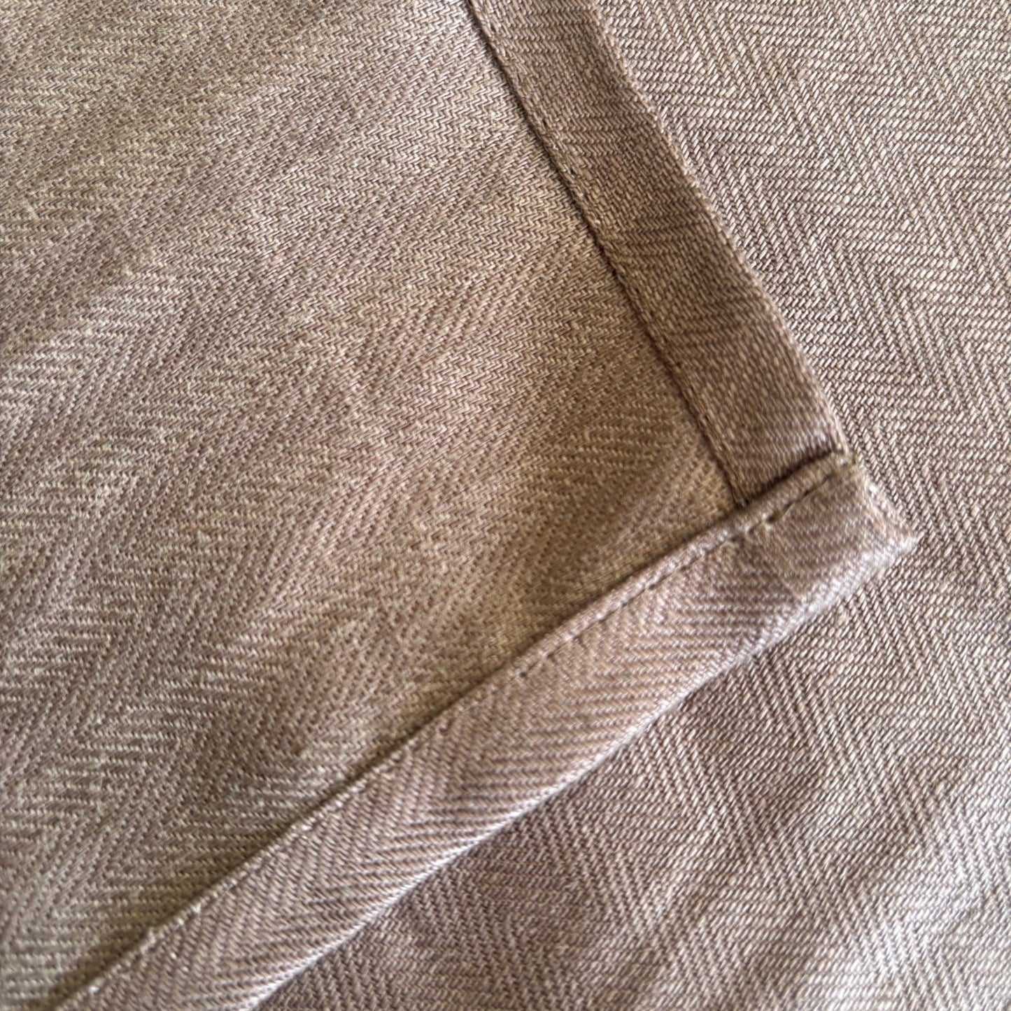 Eclectic Charvet Editions chocolate brown 100% linen tablecloth with a detailed herringbone weave and stitched hem