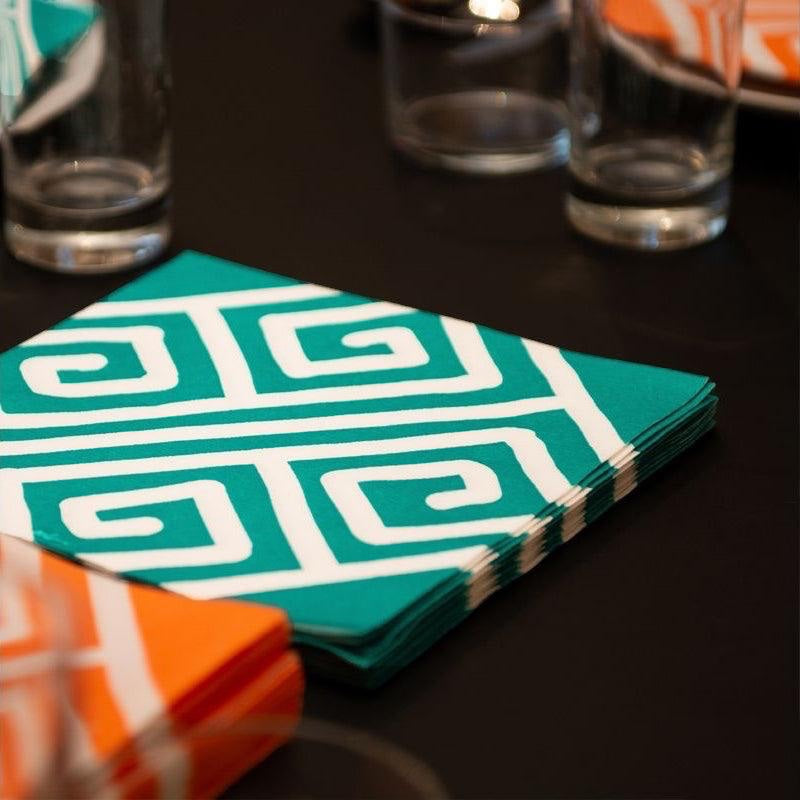 Eclectic Françoise Paviot Milos Vert green and white geometric airlaid dinner napkins on a dark table setting.