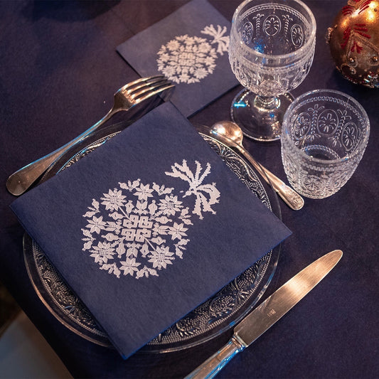 Eclectic Françoise Paviot midnight blue airlaid dinner napkins with silver embroidered-effect snowflake patterns on a table