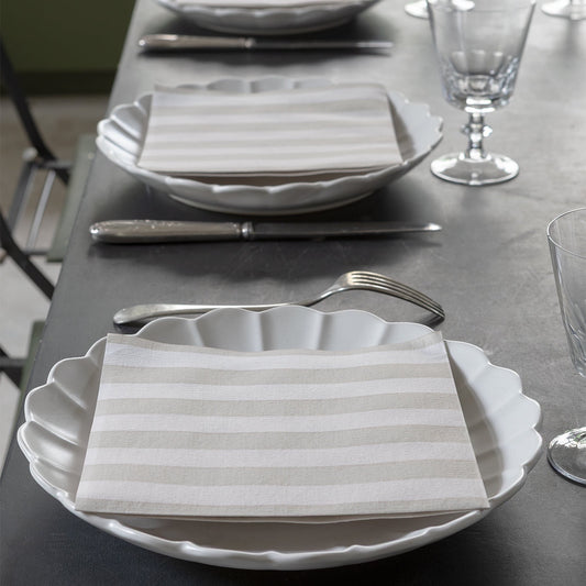 Eclectic Françoise Paviot Rayure Mocha striped airlaid dinner napkins on white scalloped plates at a table setting