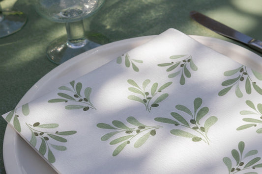 Eclectic Françoise Paviot Olivier cocktail napkin with green olive branch pattern on a white plate