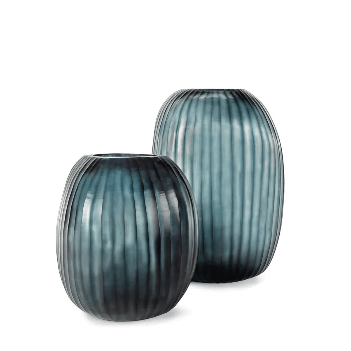 Eclectic Guaxs Patara mouth-blown glass vases in ocean blue with a hand-cut pleated texture and rounded silhouette.