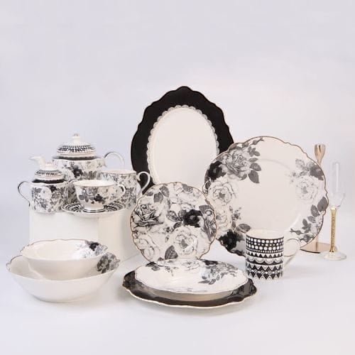 Eclectic Jenna Clifford Black Rose collection featuring floral bone china plates, bowls, and tea set on white surface