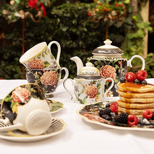 Eclectic Jenna Clifford Botanica Rose fine china tea set and oval platter with floral motifs on a table