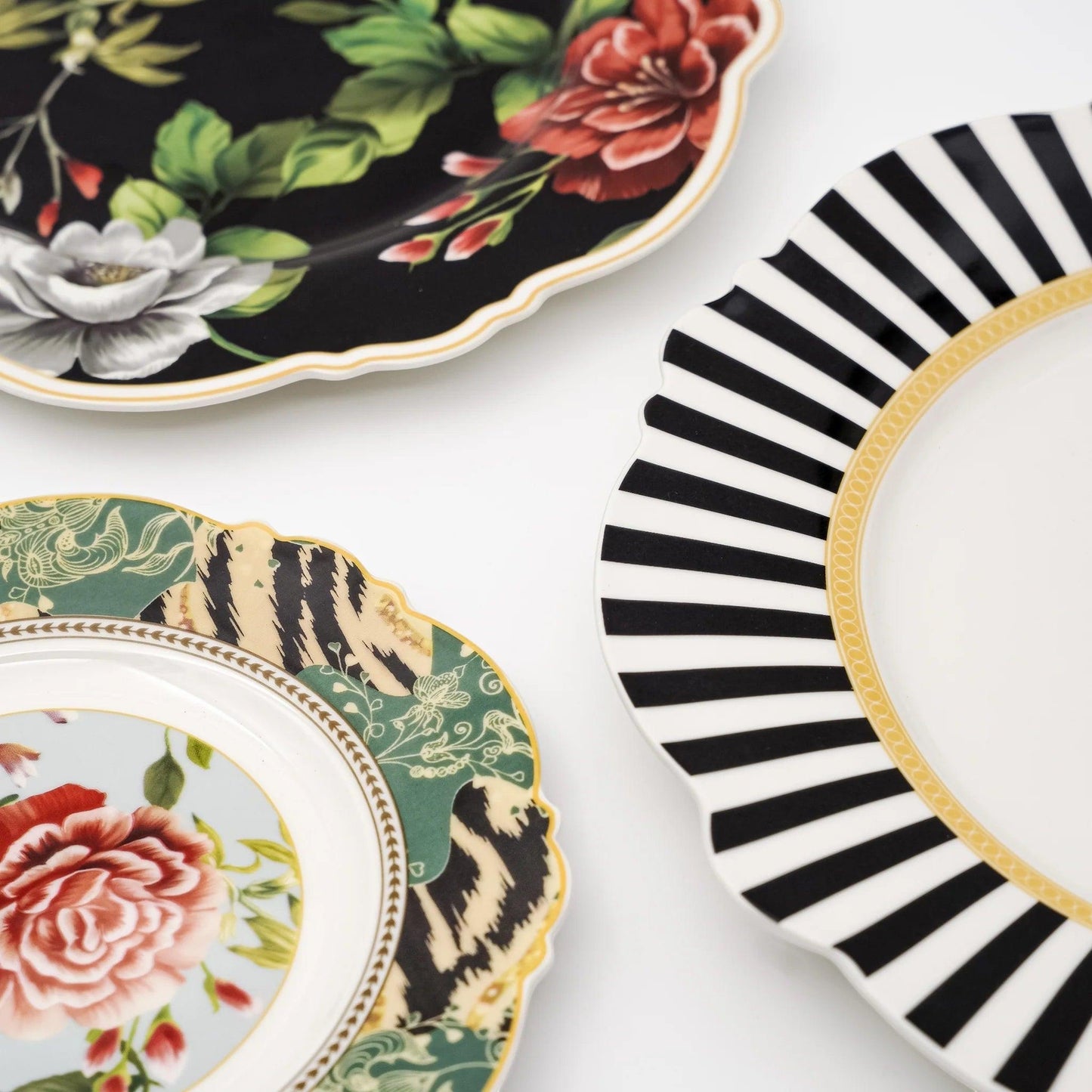 Eclectic Jenna Clifford fine china plates featuring botanical rose patterns, gold accents, and black and white stripes.
