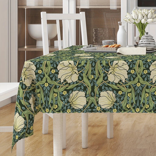Eclectic Morris vintage floral linen blend tablecloth in green, cream, and yellow on a dining table.