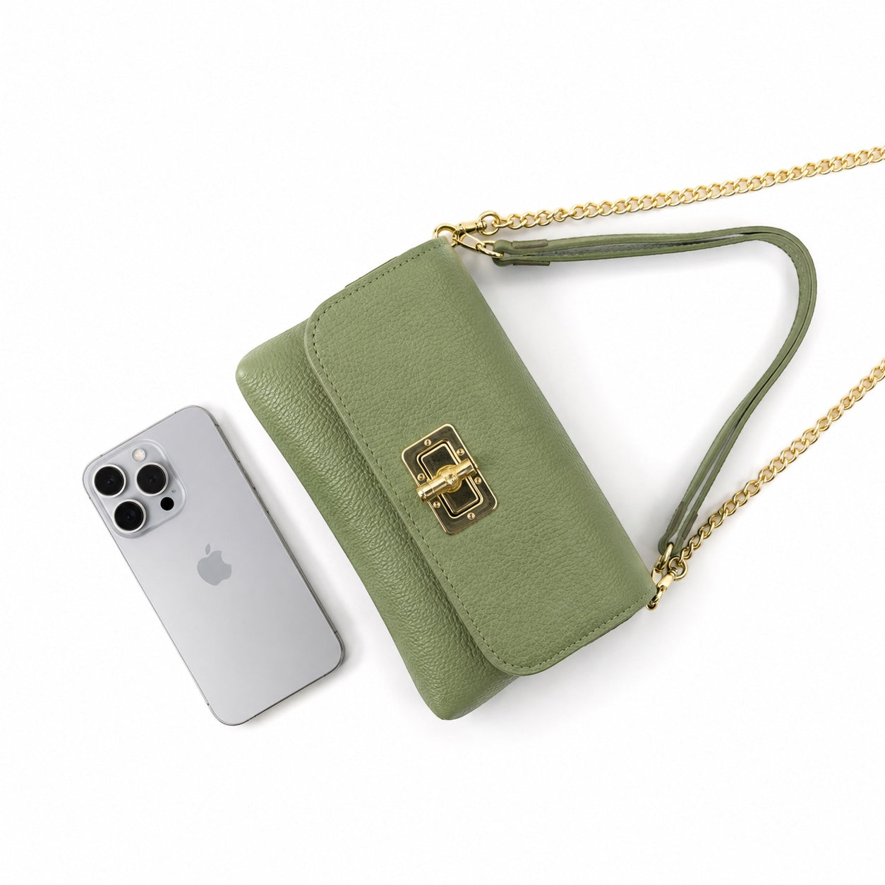 Eclectic olive pebbled leather clutch with gold bamboo-inspired clasp and chain strap next to a smartphone.