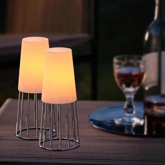 Eclectic set of two Philippi Lighthouse tea light holders with polished silver wire bases and frosted glass shades.