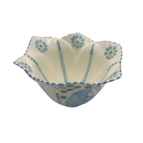 Eclectic Potterseed handcrafted ceramic tulip bowl with blue and green floral patterns on a cream background.