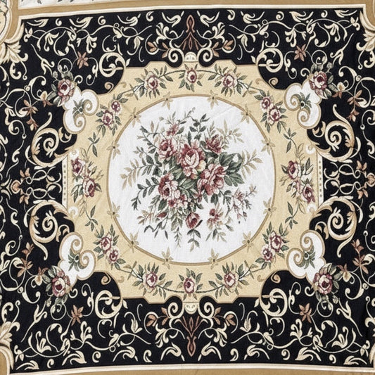 Eclectic round tablecloth featuring a black, gold, and ivory baroque floral pattern on lightweight fabric.