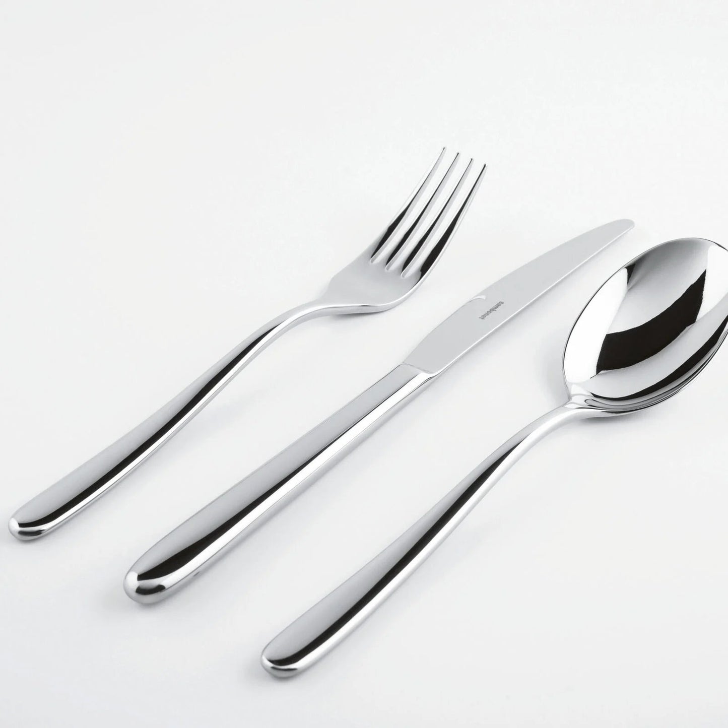 Eclectic Sambonet Hannah stainless steel cutlery set including a fork, knife, and spoon with a mirror-polished finish.