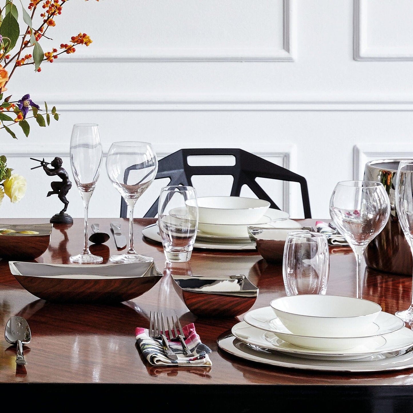 Eclectic Sambonet Linea Q stainless steel bread basket and square bowls set on a formal dining table