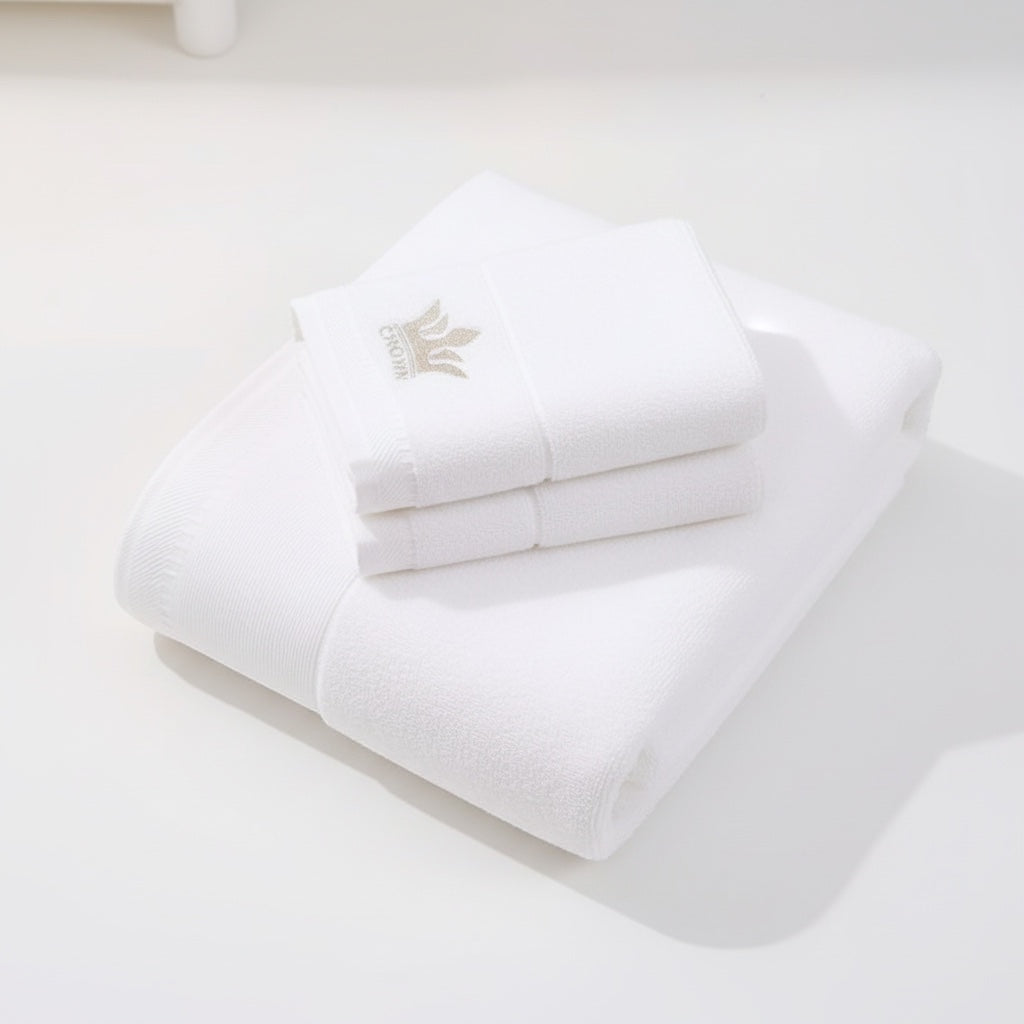 Eclectic white 100% cotton guest towel featuring an elegant embroidered crown detail for a sophisticated bathroom look.