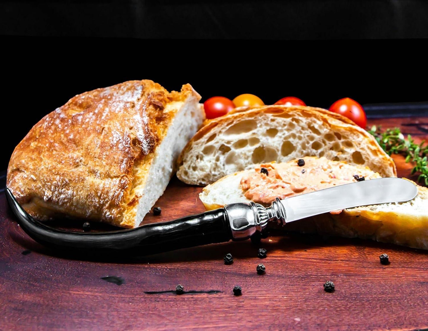 Eclectic Diana Carmichael Impondo Zulu pâté knife with a polished ebony resin horn handle and stainless steel blade.