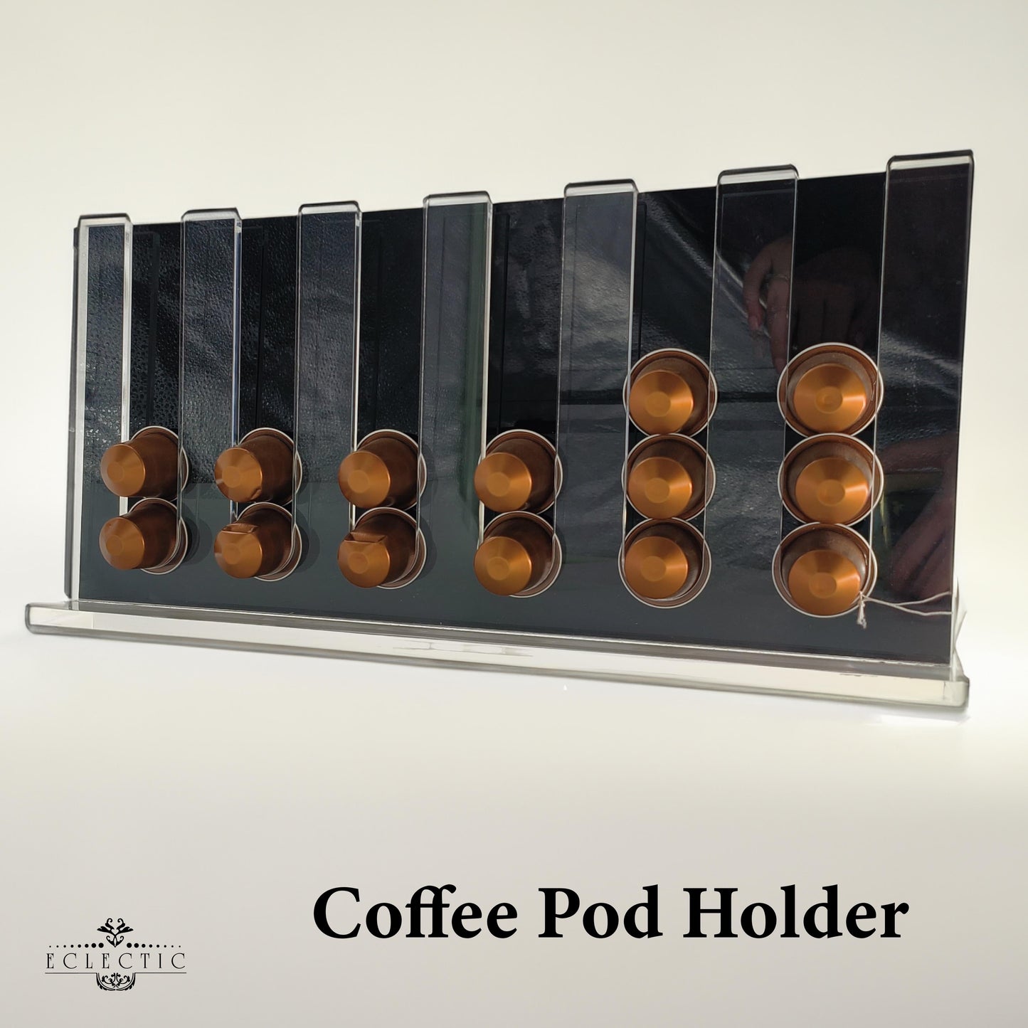 Eclectic clear acrylic espresso pod stand holding coffee capsules on a modern countertop display