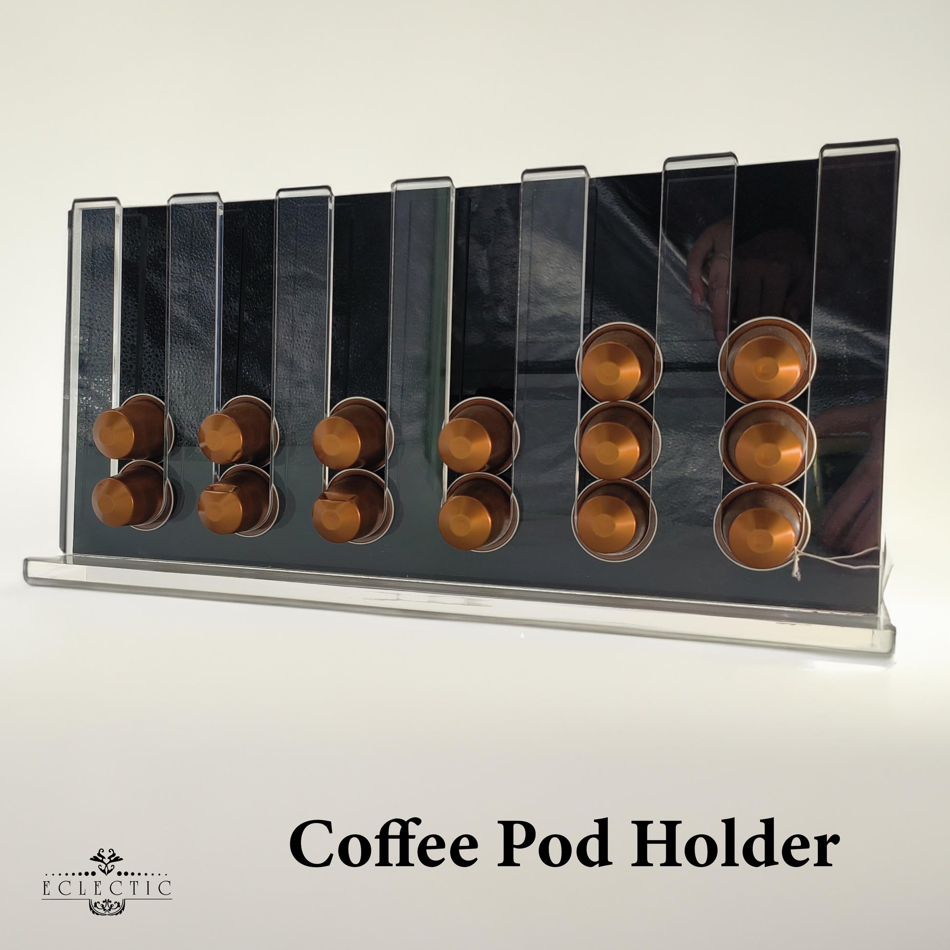 Eclectic clear acrylic espresso pod stand holding coffee capsules on a modern countertop display