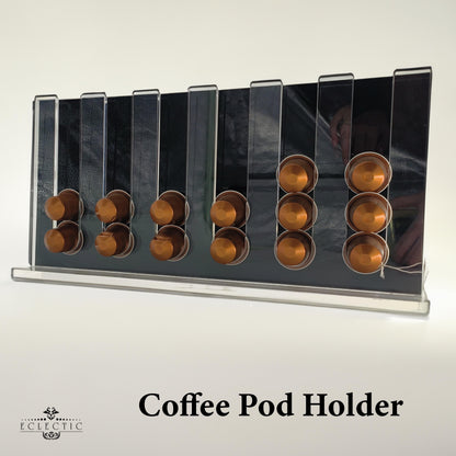 Eclectic clear acrylic espresso pod stand holding coffee capsules on a modern countertop display