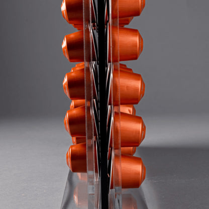 Eclectic clear acrylic espresso pod stand holding orange coffee capsules in a slim double-sided countertop display.