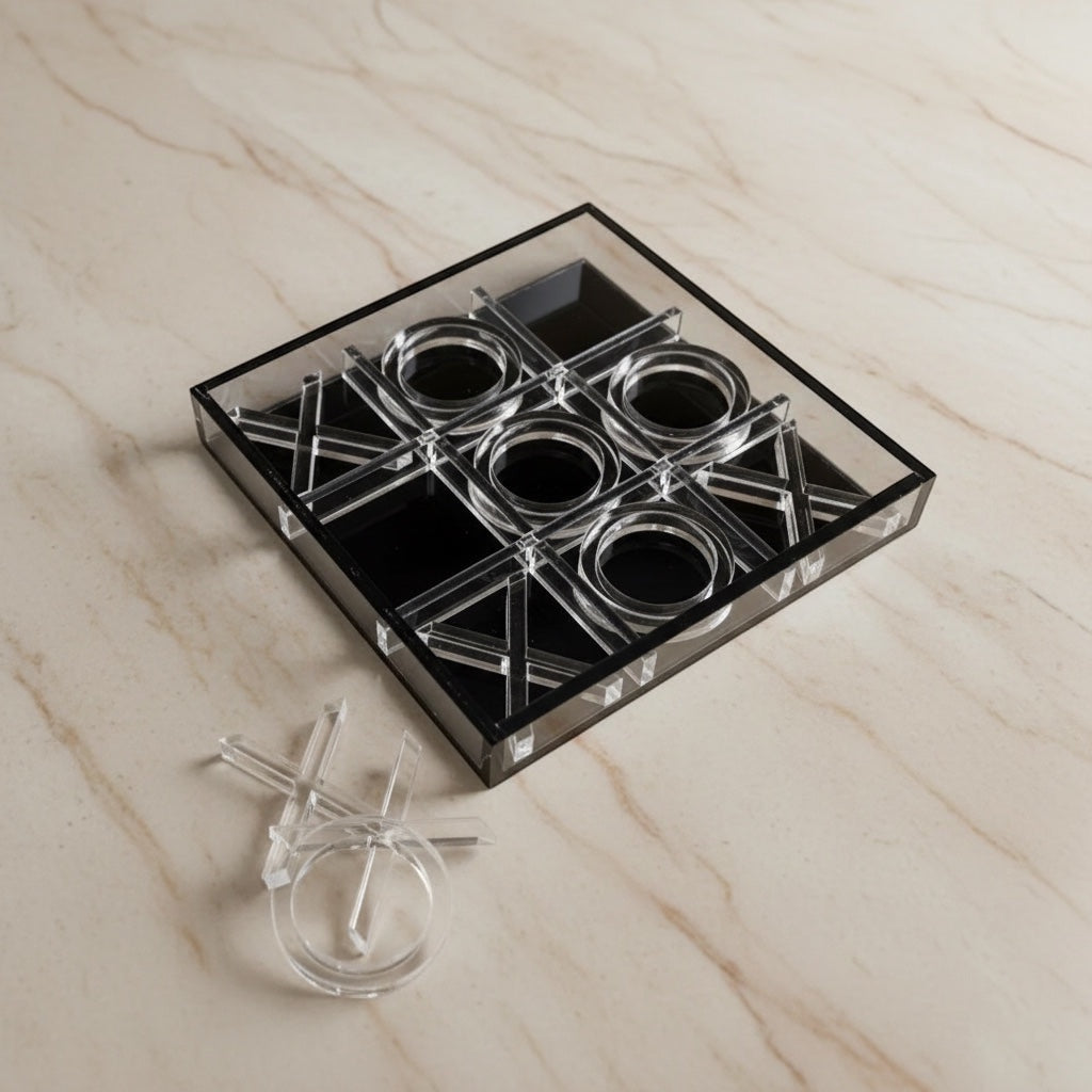Eclectic modern acrylic noughts and crosses game with clear and black pieces on a marble surface