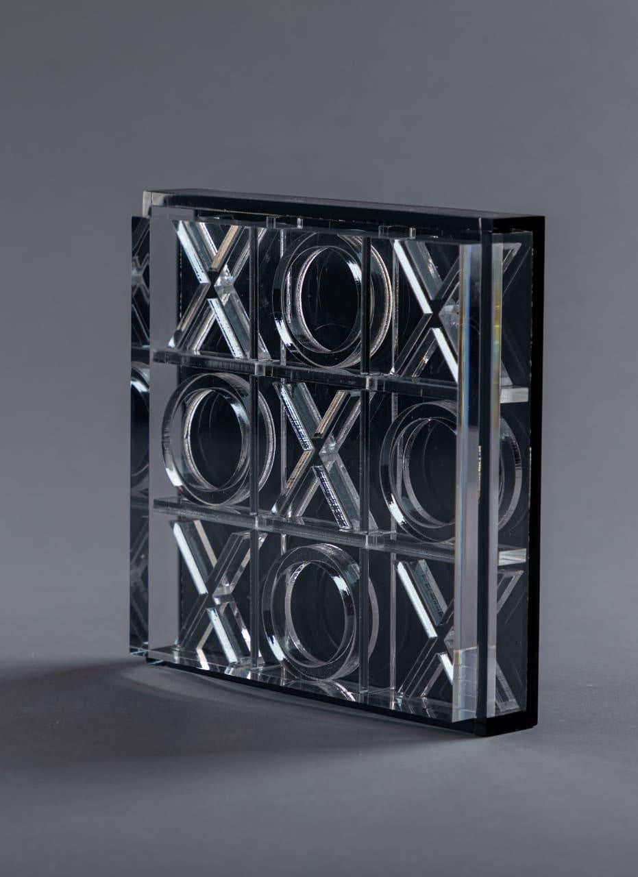 Eclectic modern acrylic noughts and crosses game with clear and black finish displayed vertically