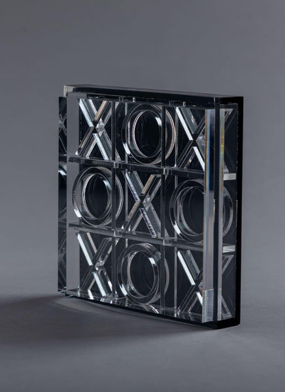 Eclectic modern acrylic noughts and crosses game with clear and black finish displayed vertically