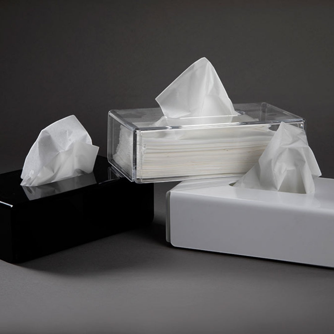 Eclectic modern rectangular acrylic tissue box covers in black, white, and clear finishes on a dark background.
