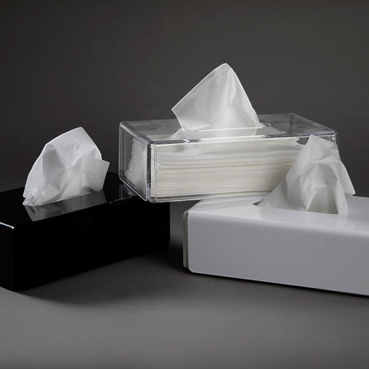 Eclectic modern rectangular acrylic tissue box covers in black, white, and clear finishes on a dark background.