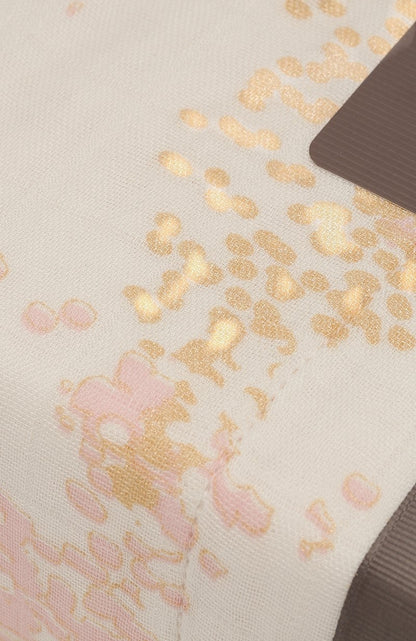 Eclectic Aden + Anais Metallic Primrose dream blanket featuring soft pink and gold floral patterns on bamboo muslin.