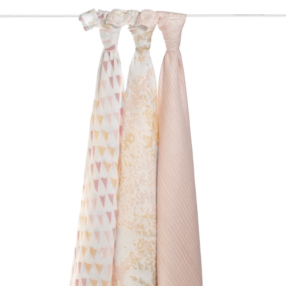 Eclectic Aden + Anais set of 3 metallic primrose birch bamboo muslin swaddles in soft pink and gold tones.