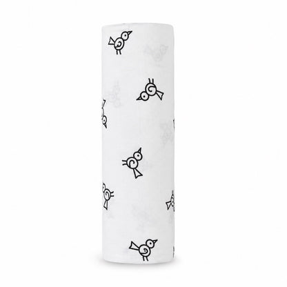 Eclectic Aden + Anais Twitter Bird muslin swaddle blanket in white with a black bird pattern, rolled up.
