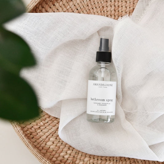 Eclectic Amanda Jayne lavender eucalyptus and rosemary room spray in a clear glass bottle on a white linen cloth