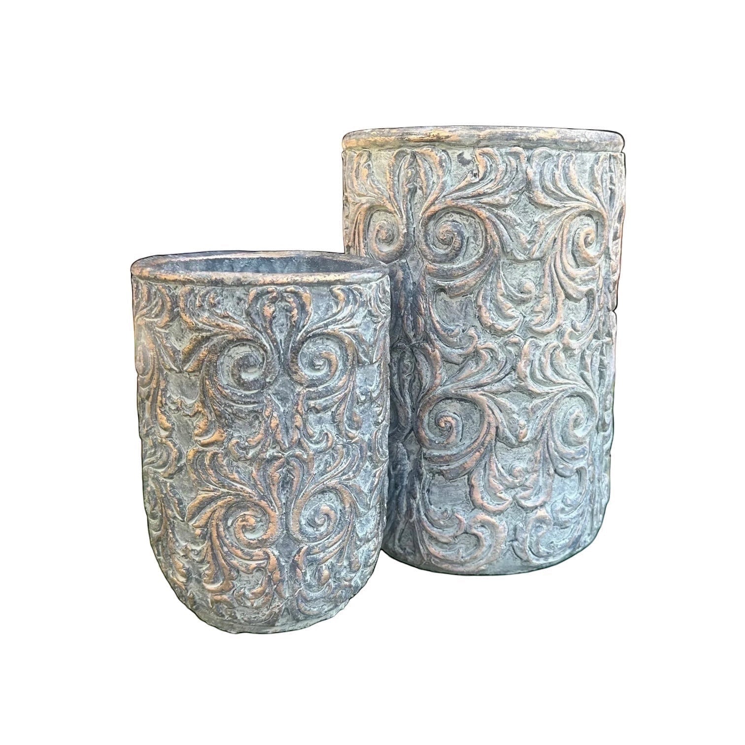 Eclectic antique-style cement planters with intricate scrollwork and an aged green patina with bronze undertones.