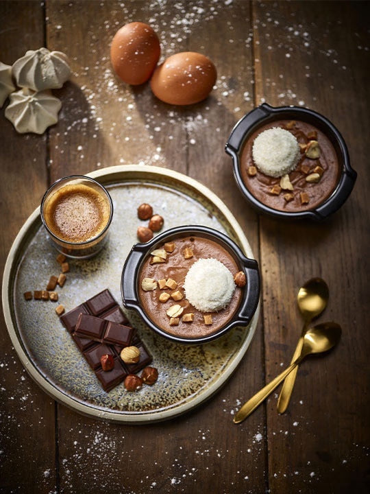 Eclectic Appolia satin black ceramic ramekins filled with chocolate dessert on a rustic wooden table with ingredients