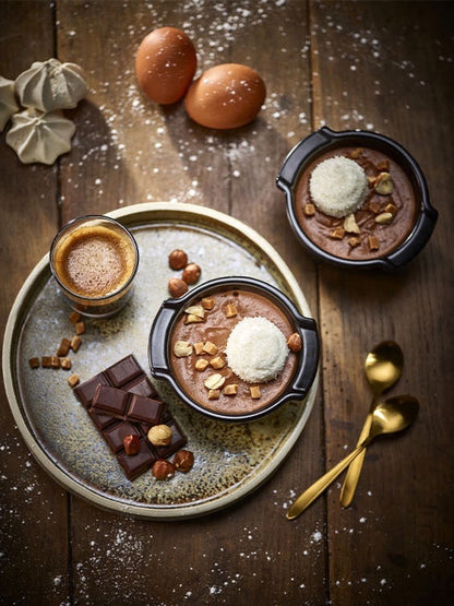 Eclectic Appolia satin black ceramic ramekins filled with chocolate dessert on a rustic wooden table with ingredients