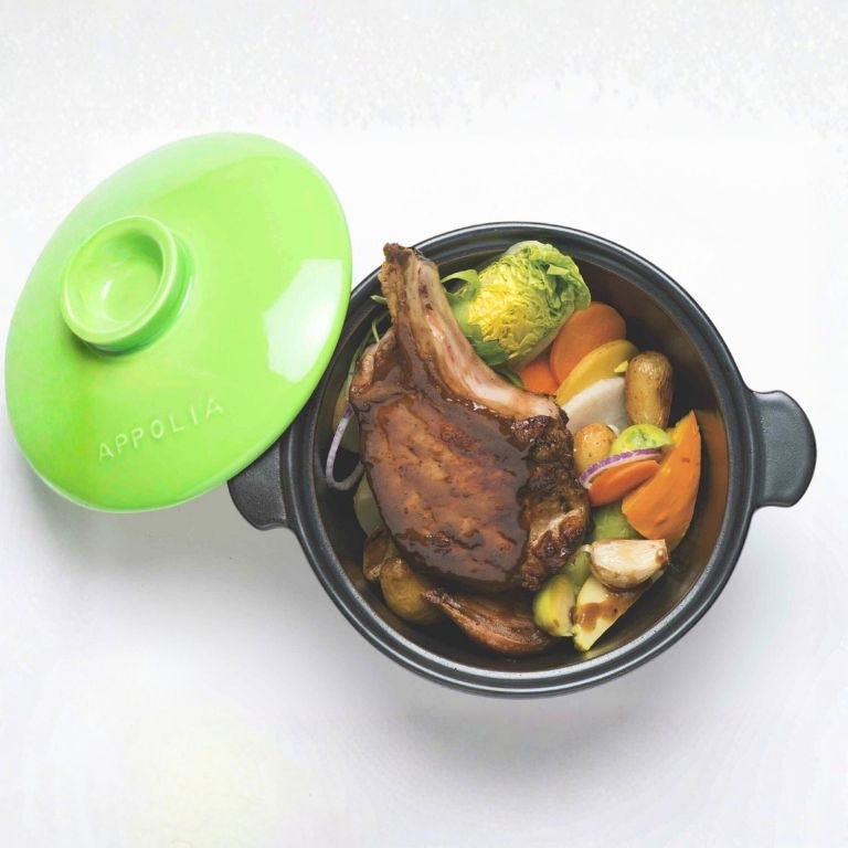 Eclectic Appolia Terre & Flamme ceramic casserole pot with a kiwi green lid containing a cooked meat and vegetable stew