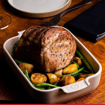 Eclectic Appolia rectangular ceramic oven dish in ecru, filled with a roasted meat and vegetable meal.