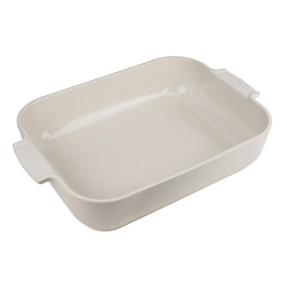 Eclectic Appolia rectangular ceramic oven dish in a soft ecru glaze with wide ribbed handles for easy serving.