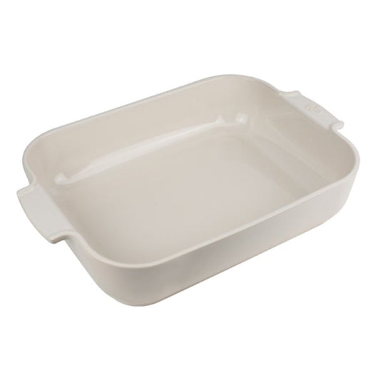 Eclectic Appolia rectangular ceramic oven dish in a soft ecru glaze with wide ribbed handles for easy serving.
