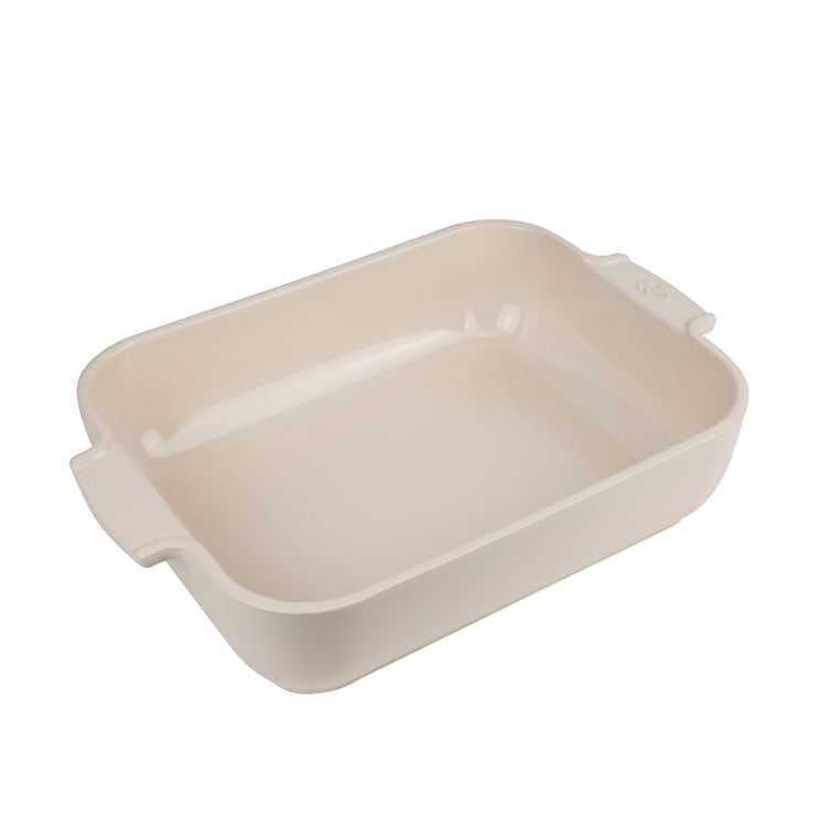 Eclectic Appolia rectangular ceramic oven dish in a soft ecru glaze with wide ribbed handles for easy serving.