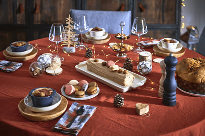 Eclectic Appolia ecru ceramic appetizer platter holding a dessert log on a festive red holiday dining table setting