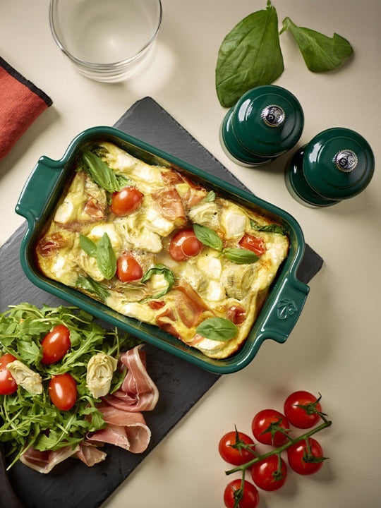Eclectic Appolia forest green ceramic rectangular oven dish filled with a baked frittata on a slate serving board.