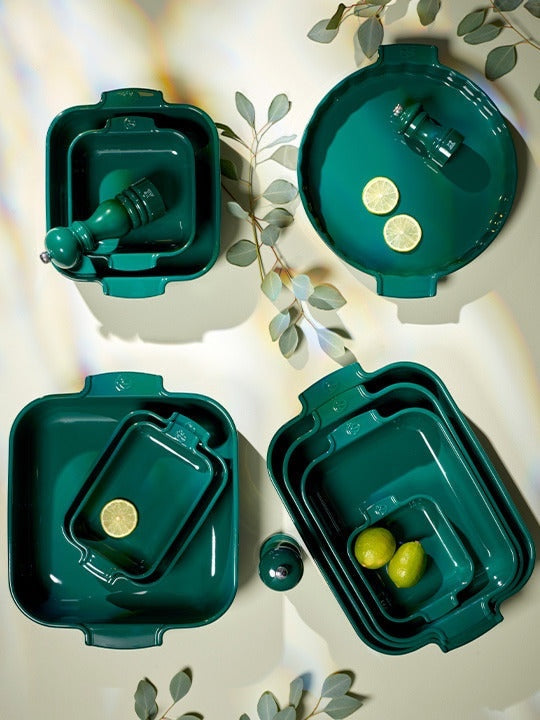 Eclectic Appolia forest green ceramic oven dishes in various square and round sizes with ribbed handles and lemons.