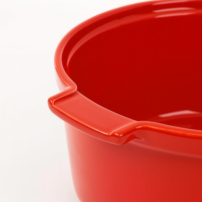 Eclectic Appolia 24cm round ceramic soufflé dish in rich red with ergonomic handles for oven-to-table serving.