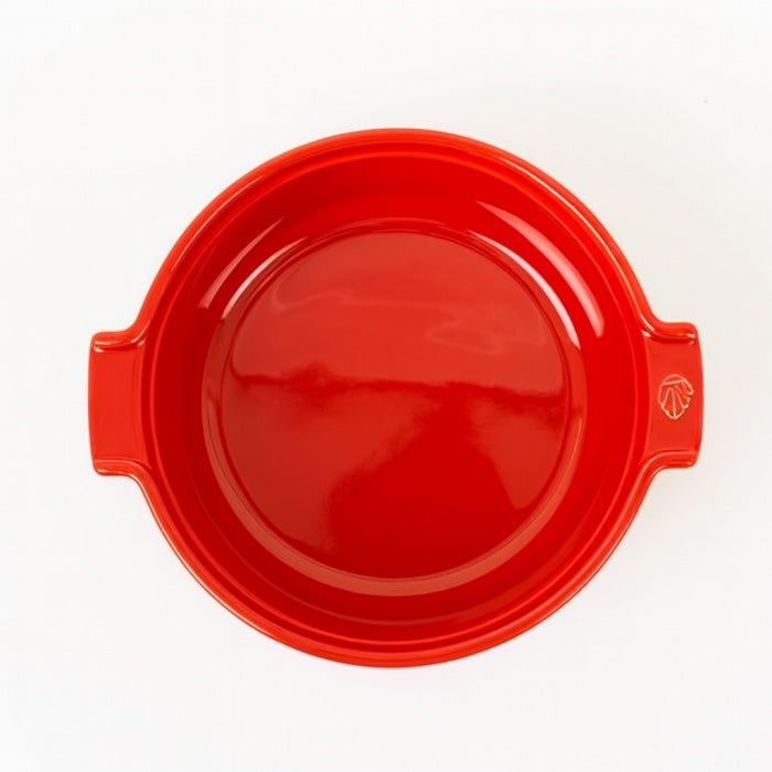 Eclectic Appolia 24 cm round ceramic soufflé dish in rich red with ergonomic handles, top-down view.