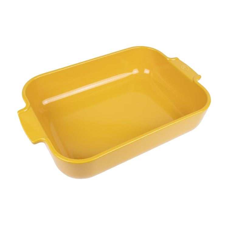Eclectic Appolia rectangular ceramic oven dish in a vibrant saffron yellow glaze with wide ribbed handles.