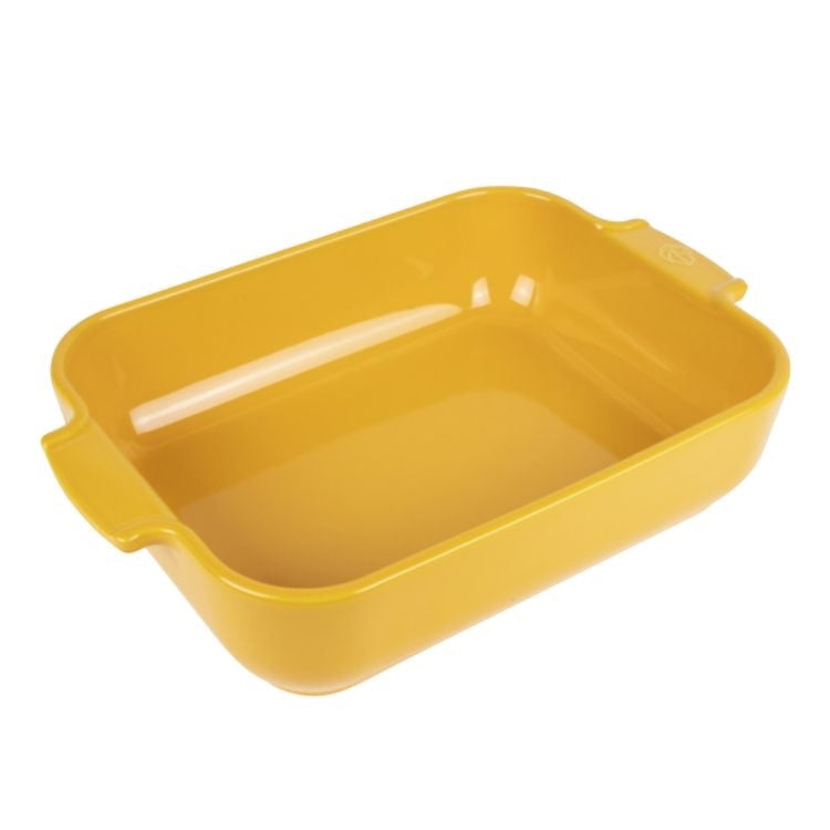 Eclectic Appolia rectangular ceramic oven dish in a vibrant saffron yellow glaze with wide ribbed handles.