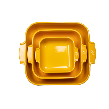 Eclectic Appolia square ceramic oven dishes in saffron yellow, nested together to show three different sizes.