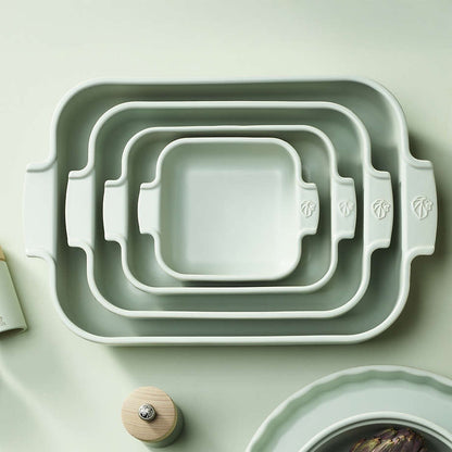 Eclectic Appolia rectangular ceramic oven dishes in sage green, nested together to show four different sizes.