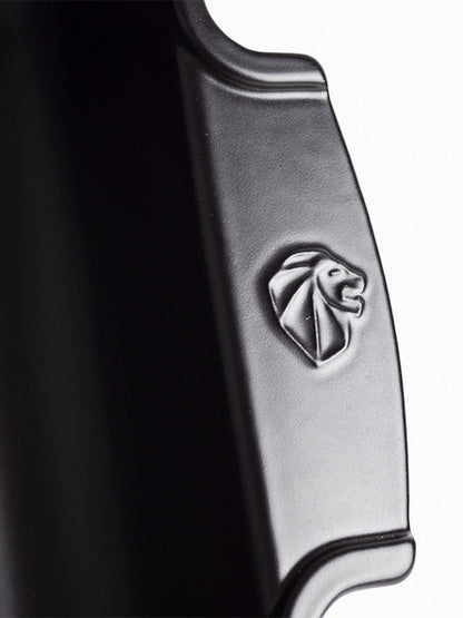 Close-up of the Eclectic Appolia ceramic oven dish in satin black featuring a detailed lion emblem on the handle.